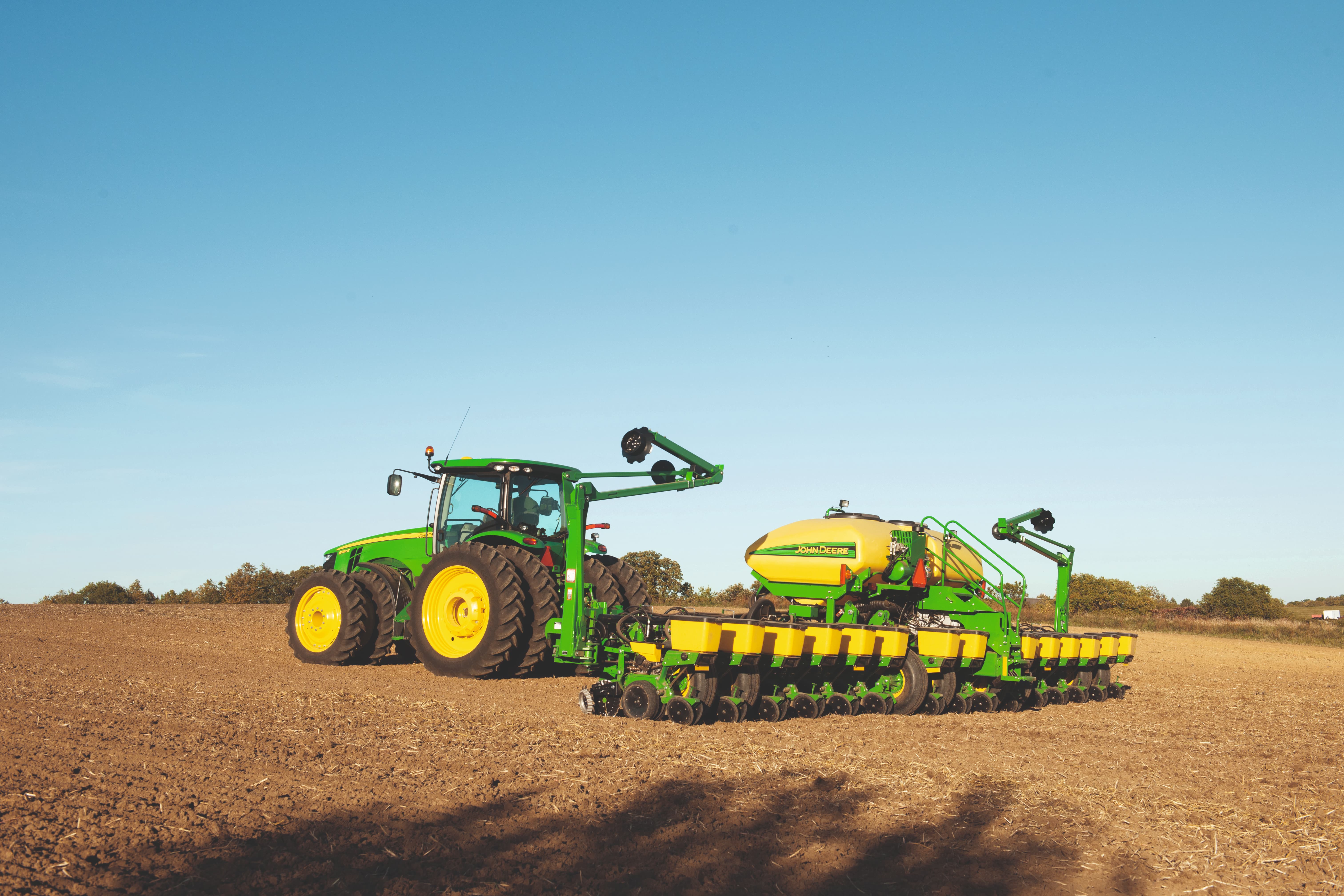 John Deere 8R row-crop tractor pulling a John Deere planter in an Ohio field