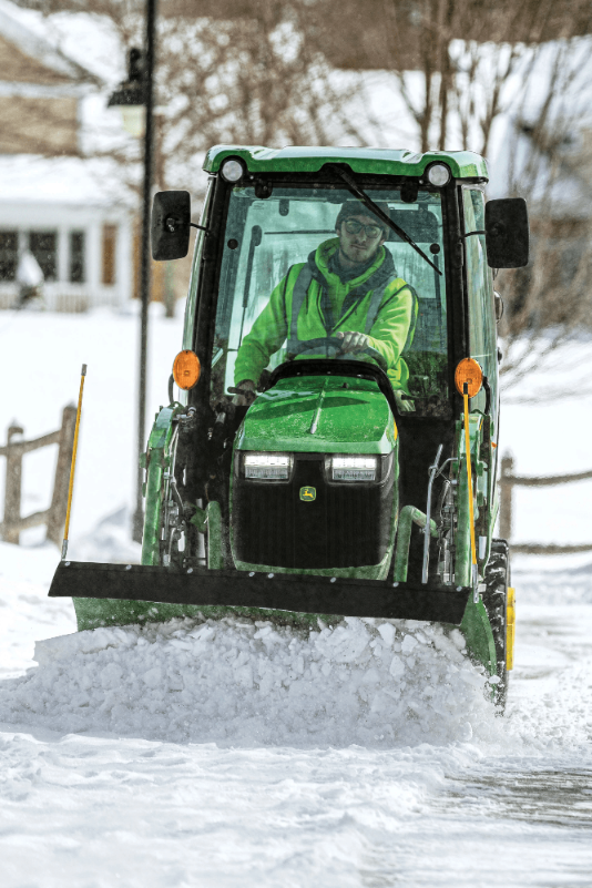 Compact Utility Tractor Pushing Snow