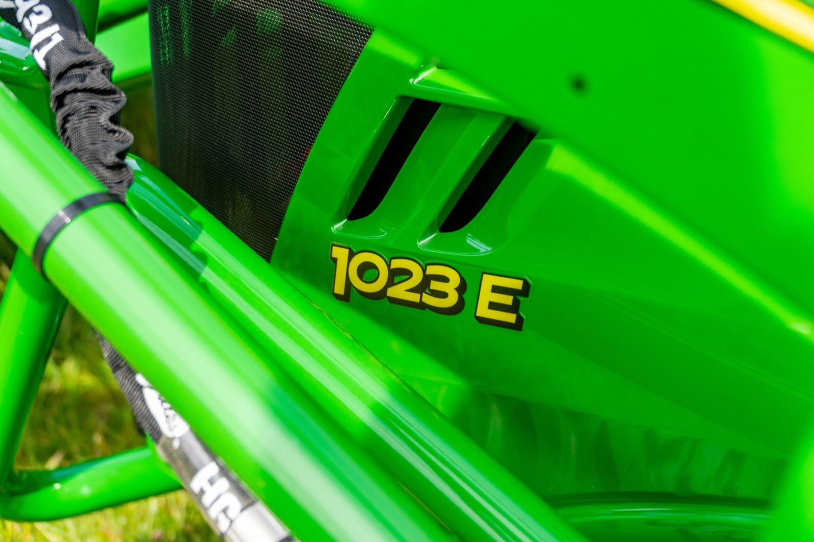 1023E badge on a John Deere sub-compact tractor