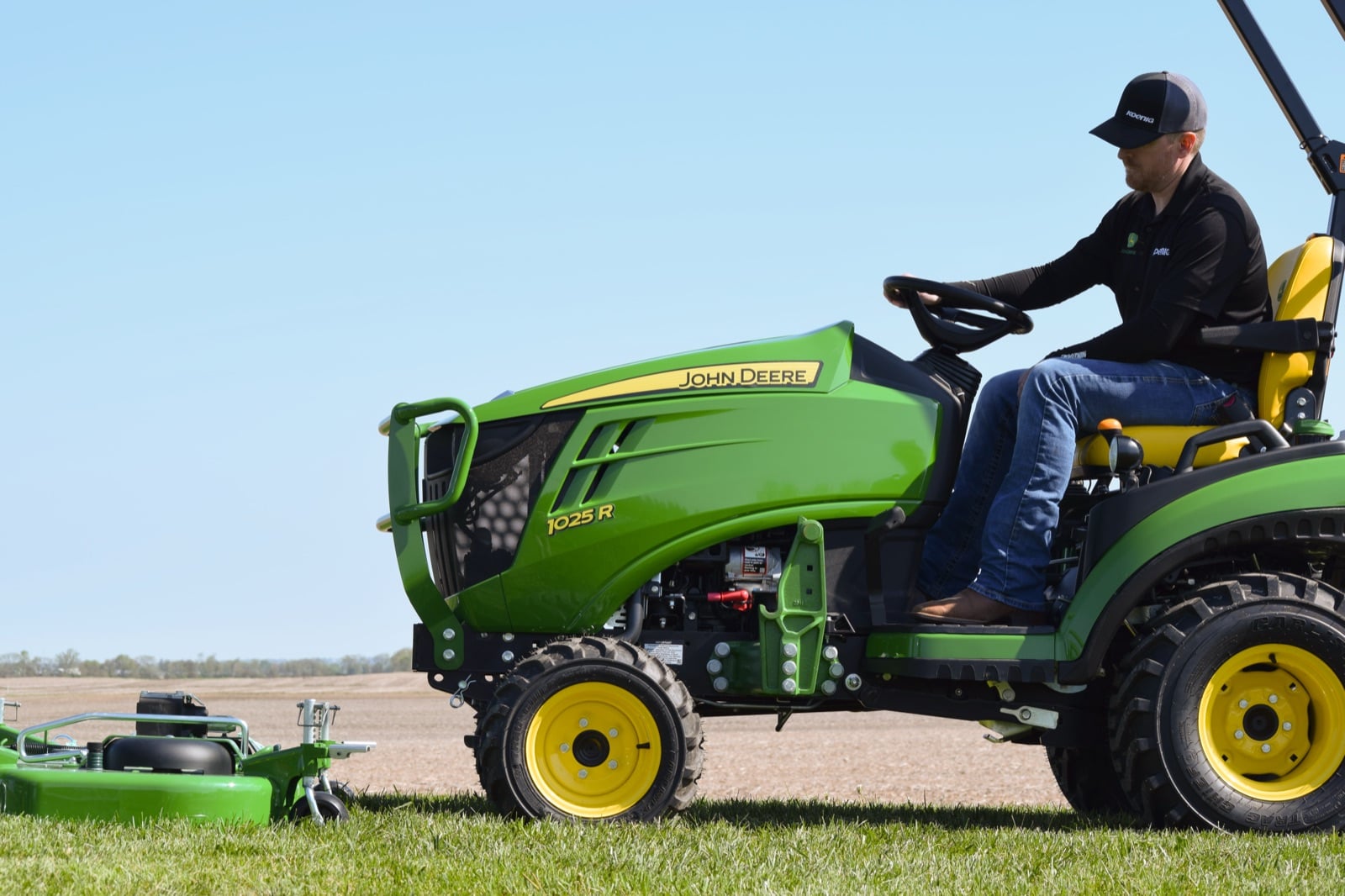 An operator mowing with a John Deere 1025R and AutoConnect deck