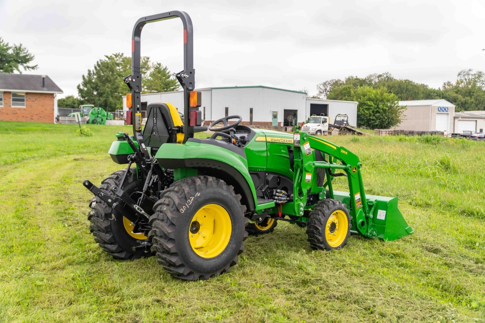 John Deere 2032R with a 220R loader, rear three-quarter view