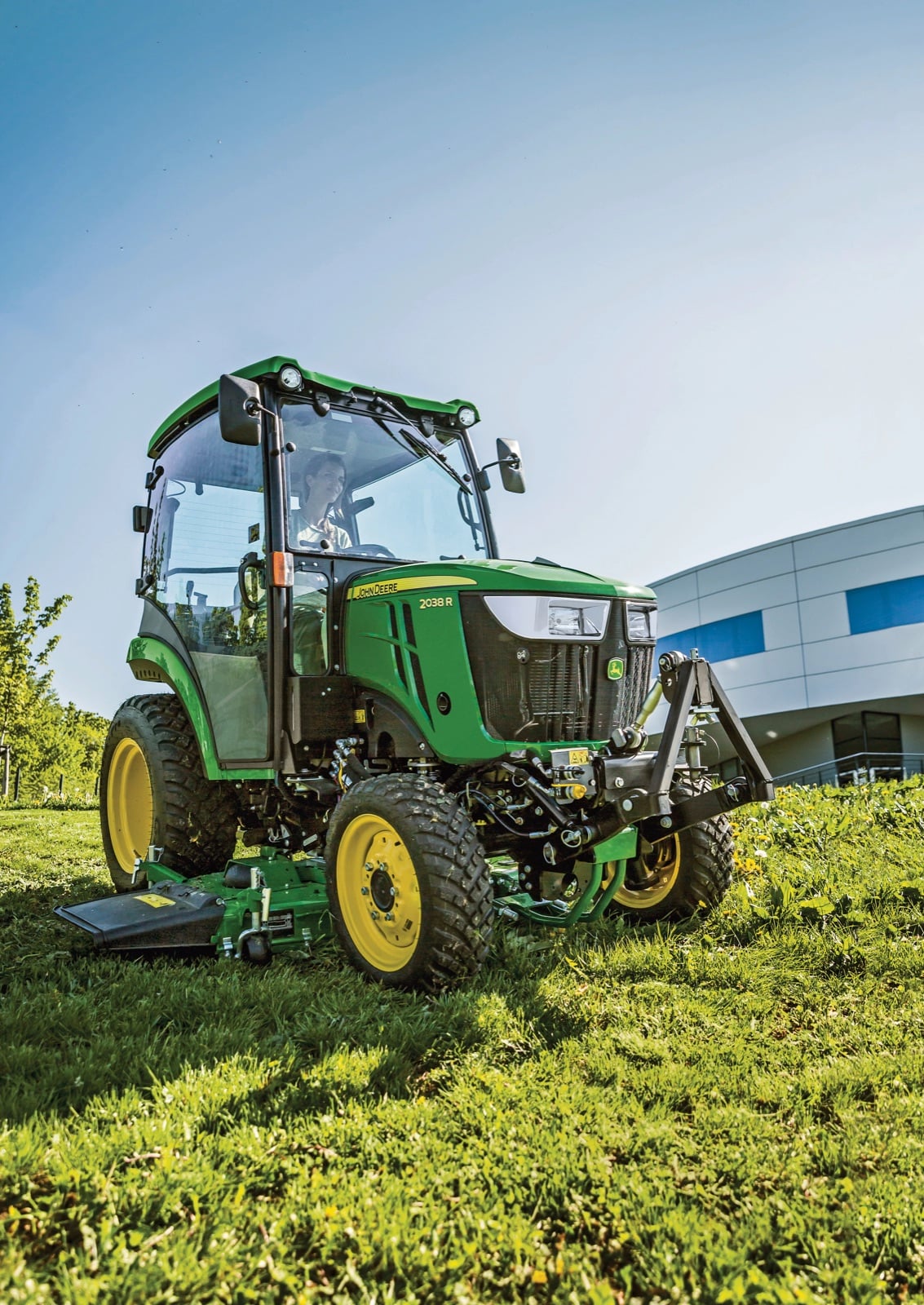 John Deere 2038R cab tractor mowing with a 72D deck