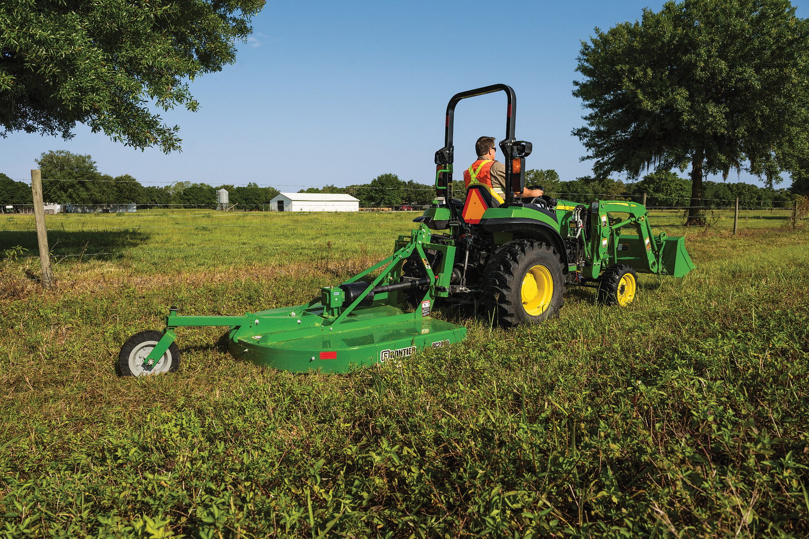 A John Deere 2032R with a rotary cutter