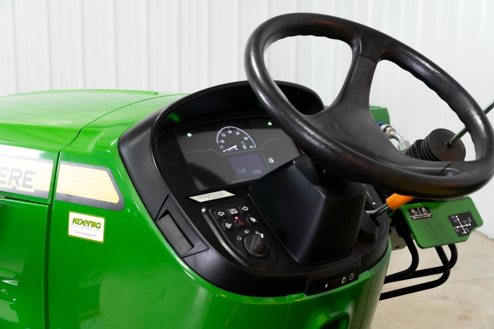 3032E badge on a John Deere compact tractor