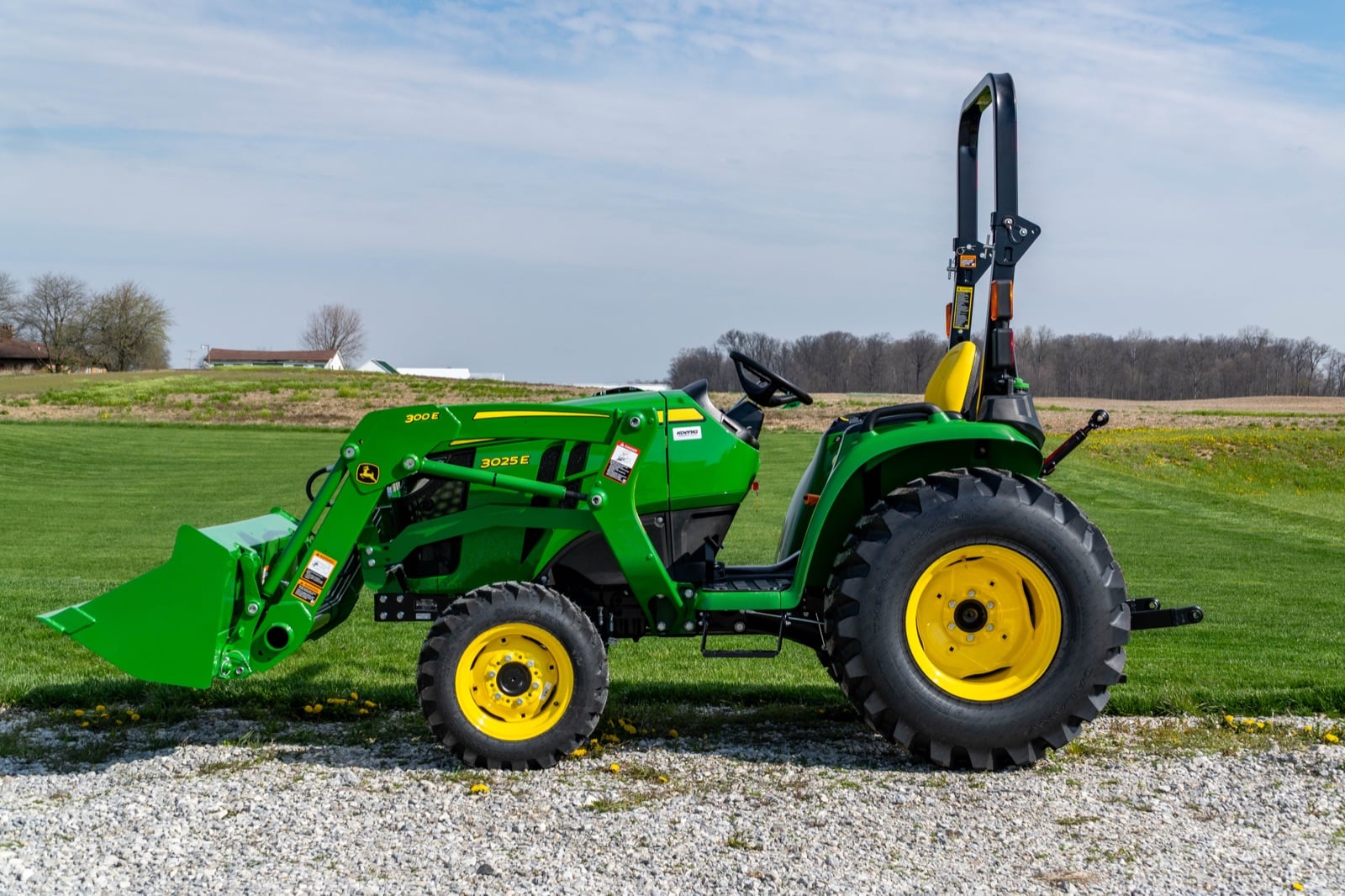 John Deere 3025E with a 300E loader, side view