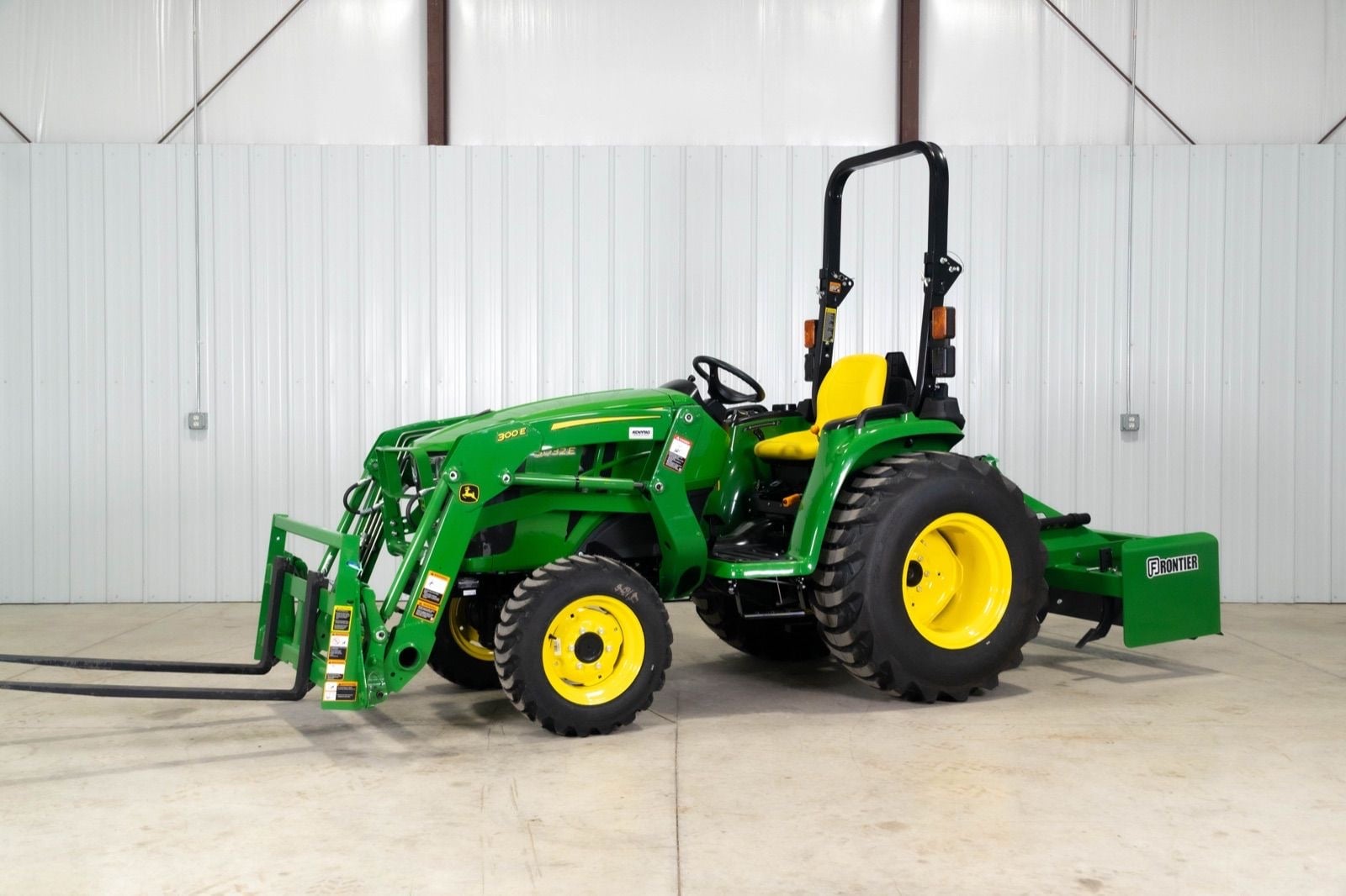 John Deere 3032E with a 300E loader, side view