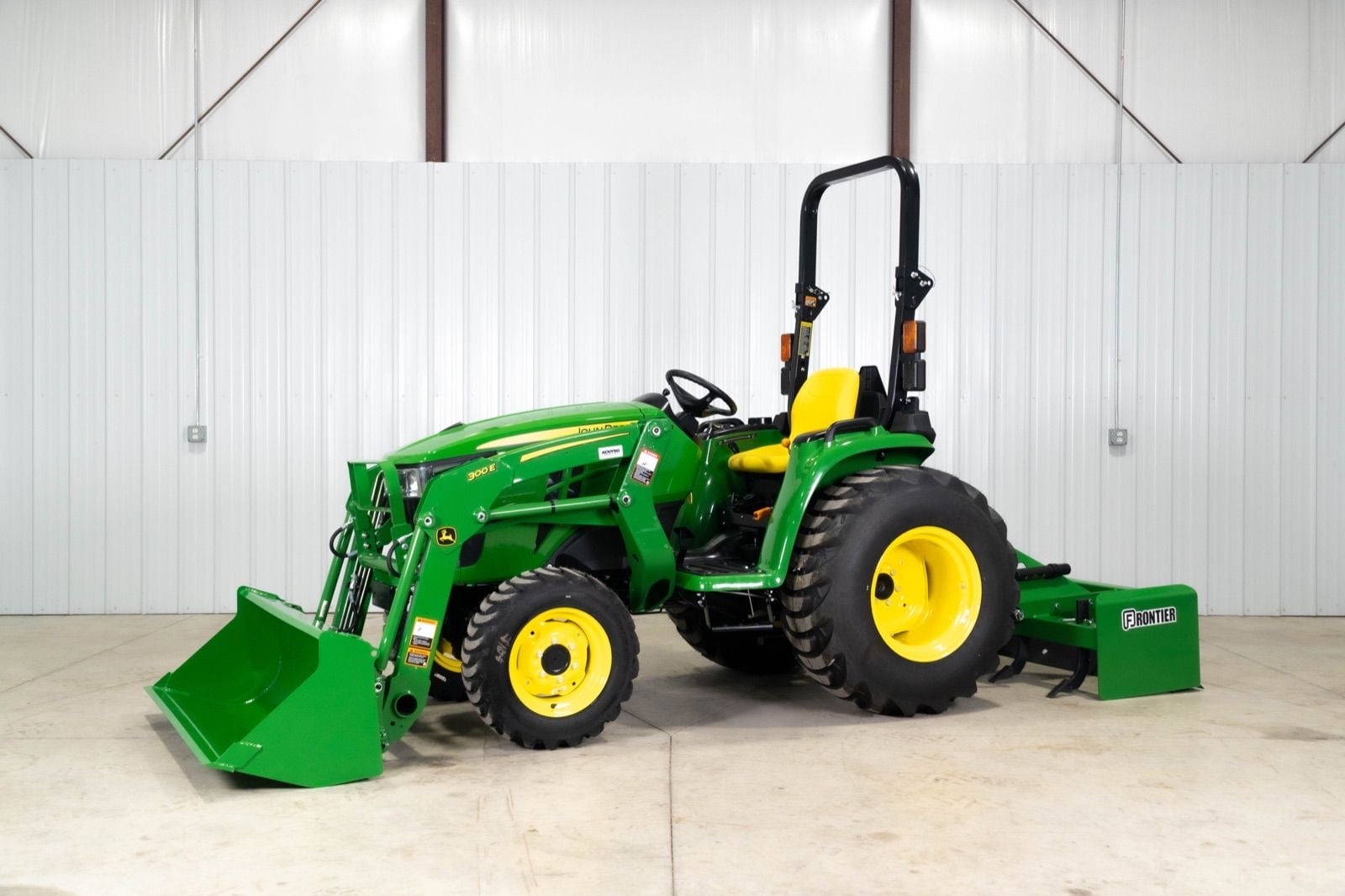 John Deere 3032E with a 300E loader and box blade