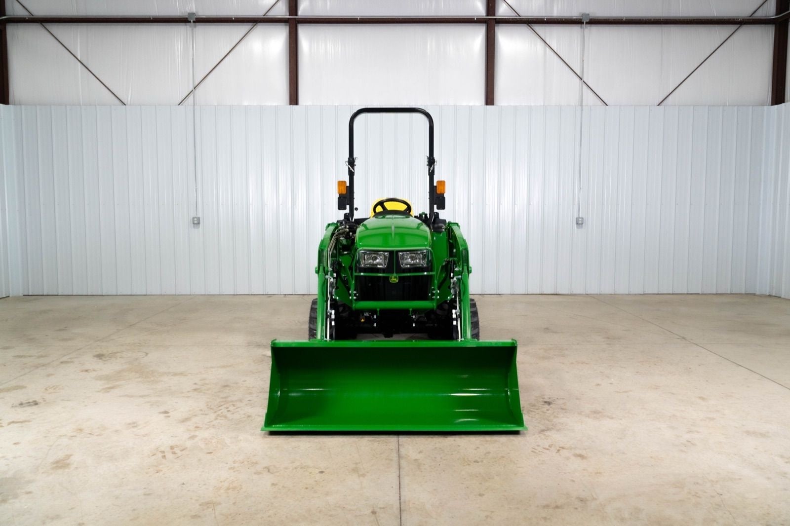 John Deere 3038E with a 300E loader, front view