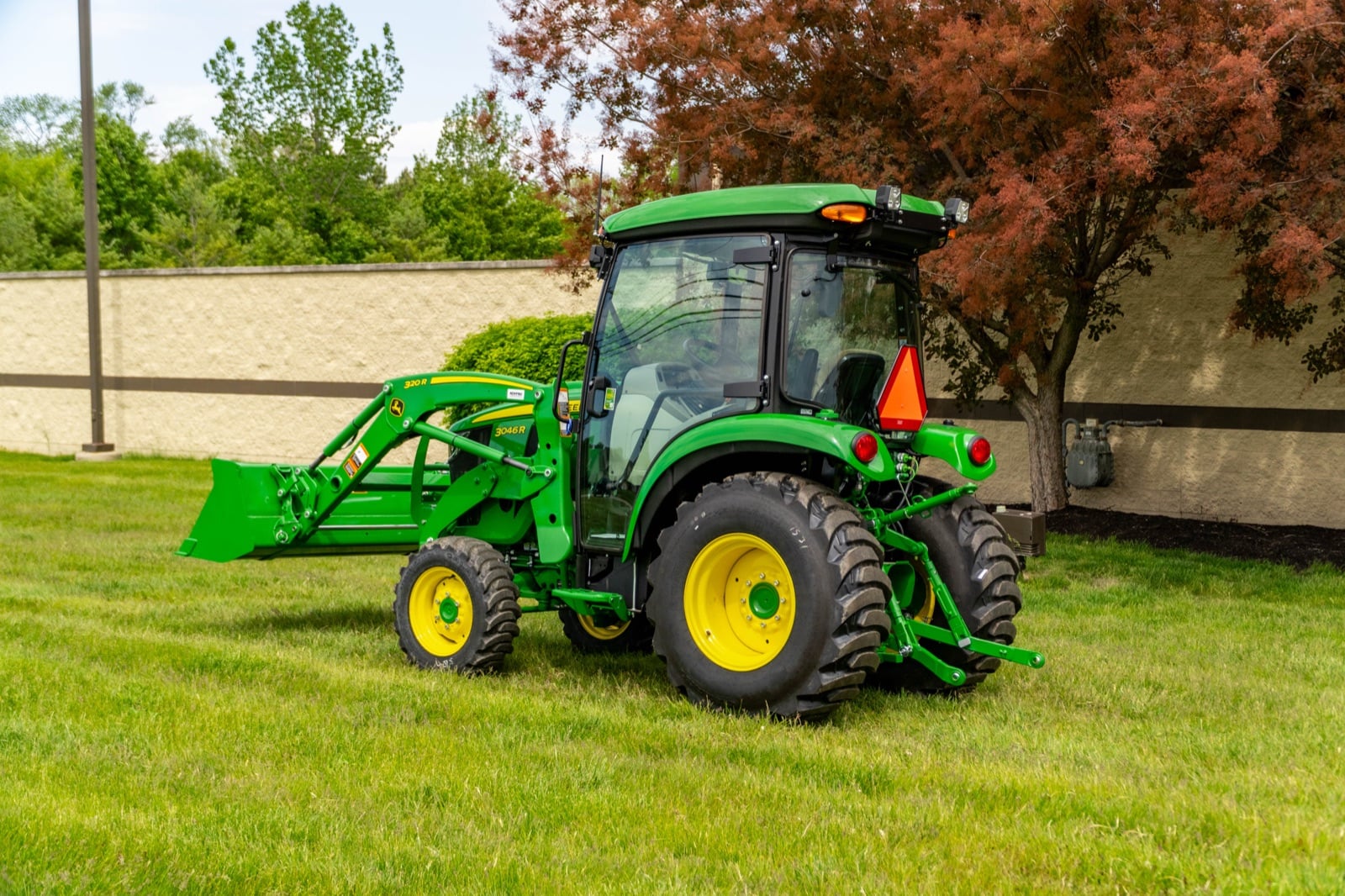 John Deere 3046R cab tractor, rear three-quarter view
