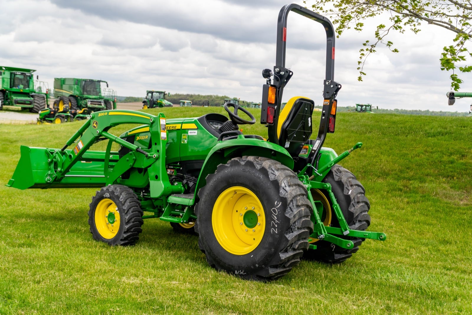 John Deere 3033R with a loader, rear three-quarter view