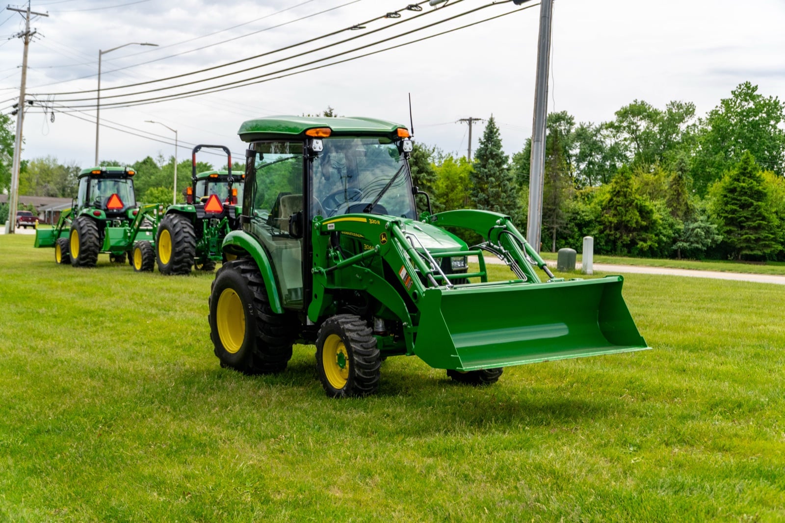 John Deere 3046R with a loader, front three-quarter view