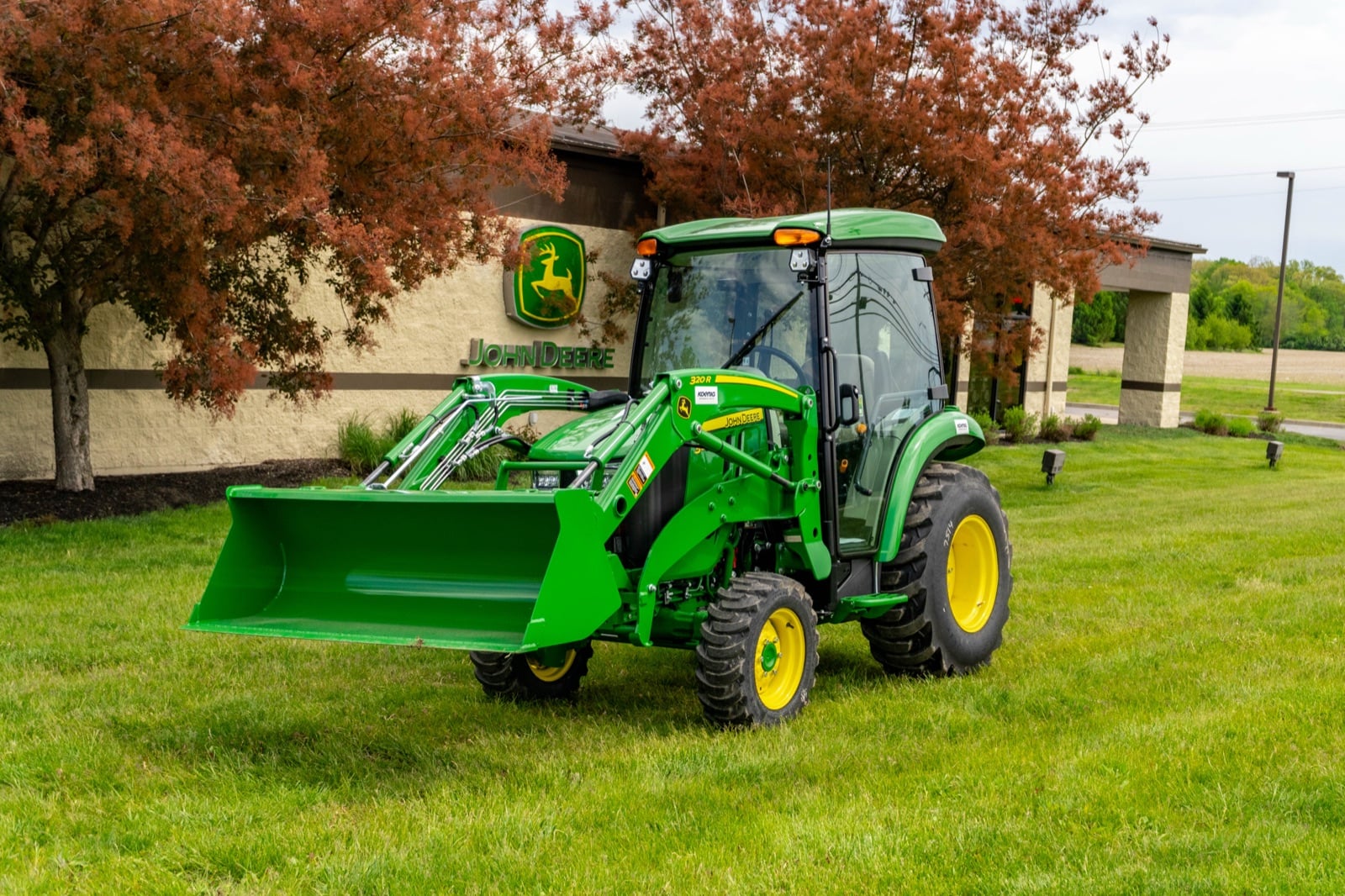 John Deere 3033R cab tractor with a loader, front three-quarter view