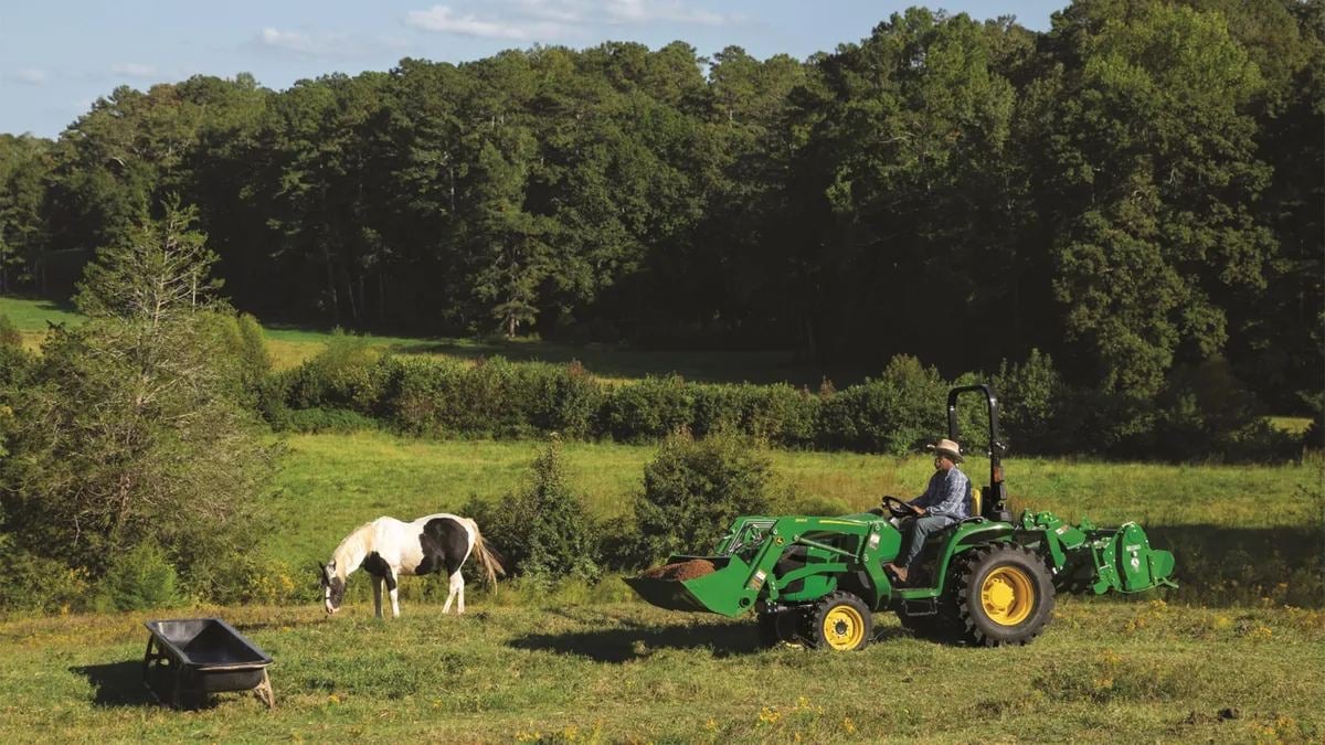 A John Deere 3 Family tractor in a pasture