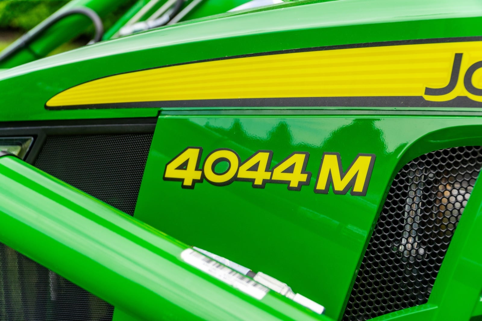 4044M badge on a John Deere compact tractor