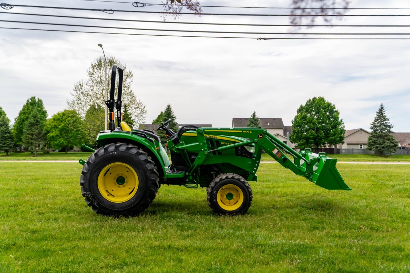 John Deere 4044M with a loader, side view