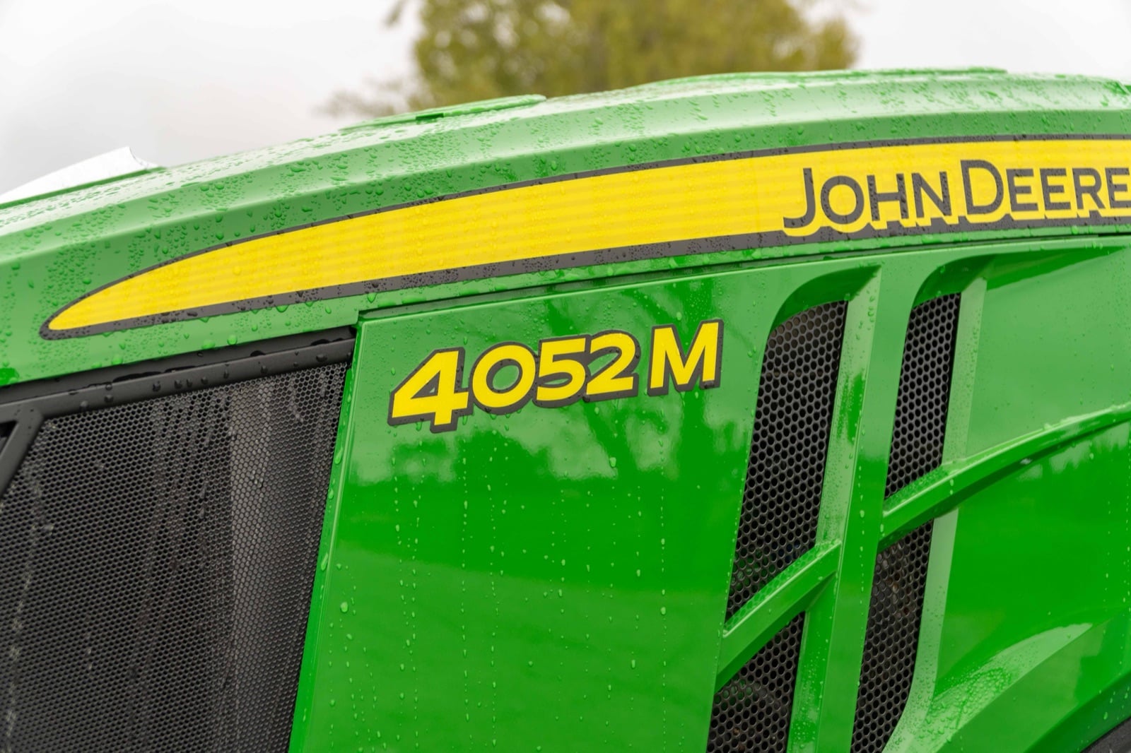 4052M badge on a John Deere compact tractor