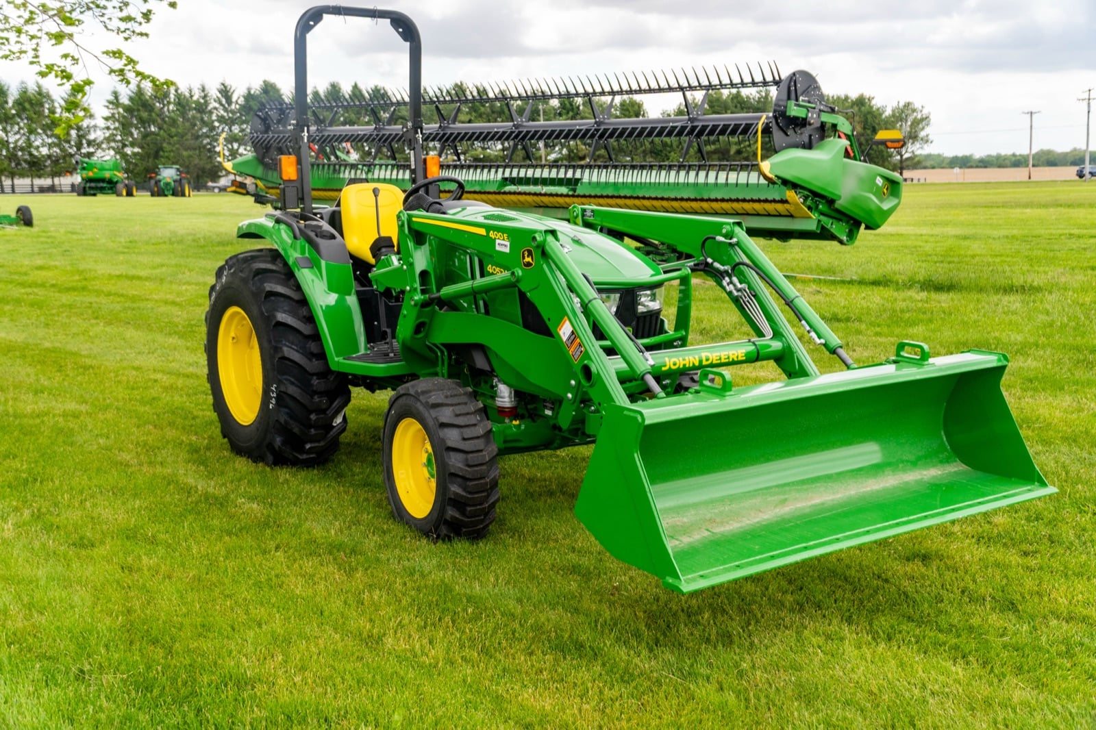John Deere 4052M with a 400E loader, front three-quarter view