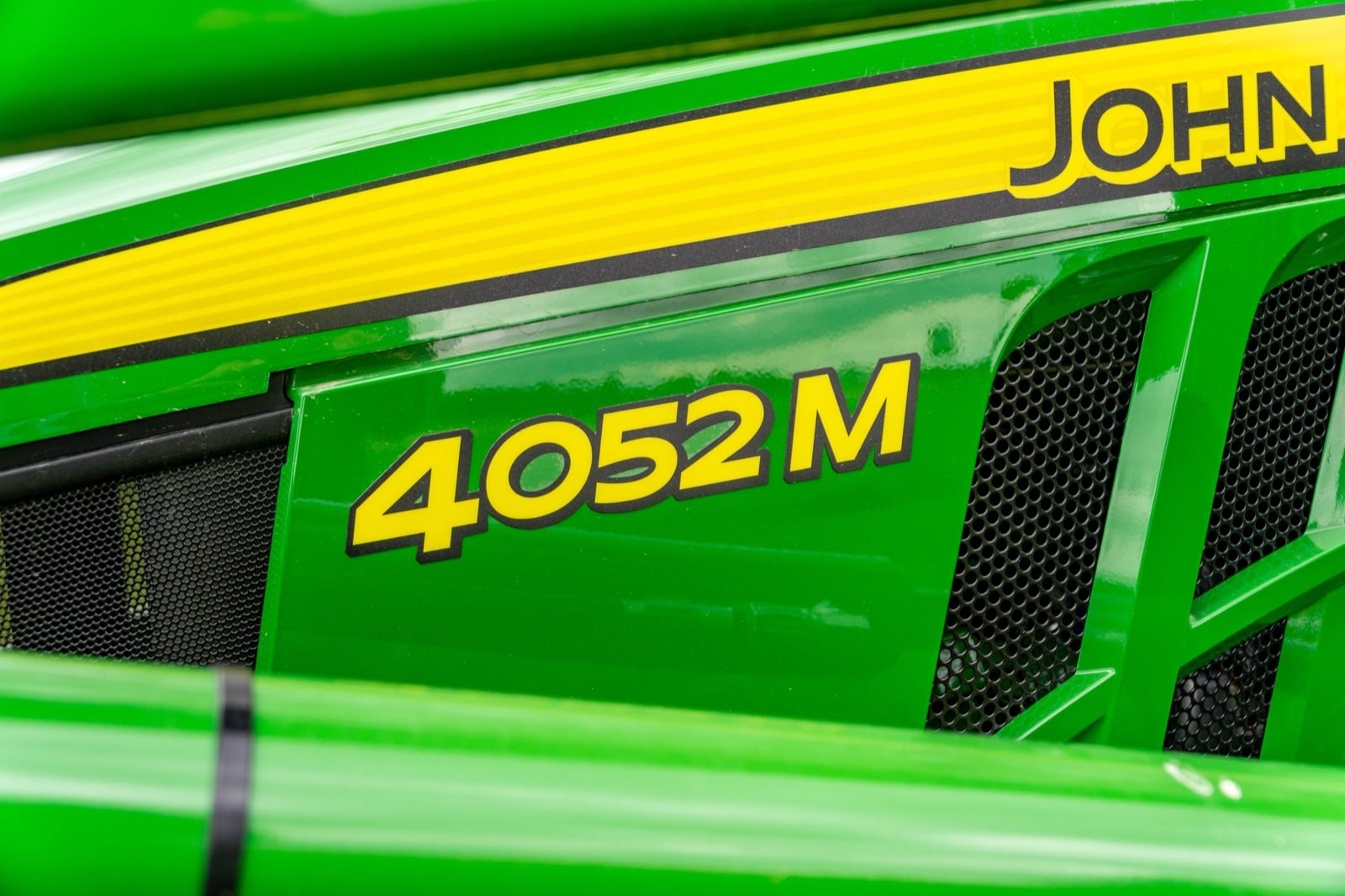 4052M badge on a John Deere compact tractor