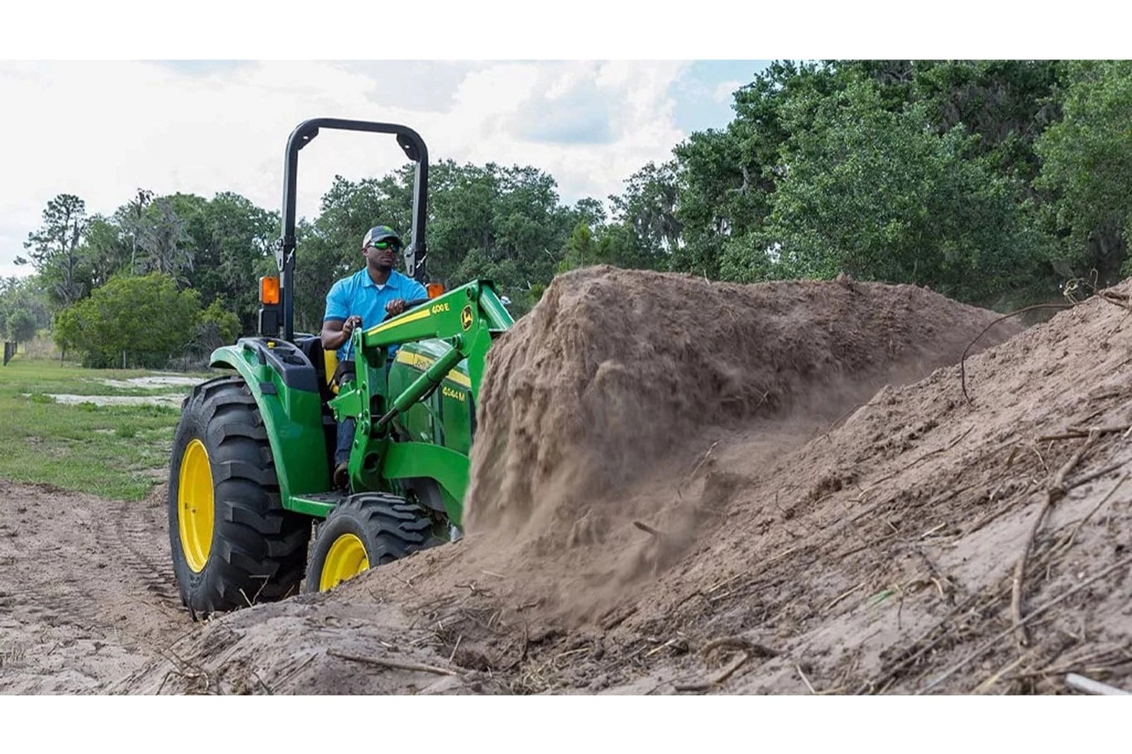 A John Deere 4044M moving dirt