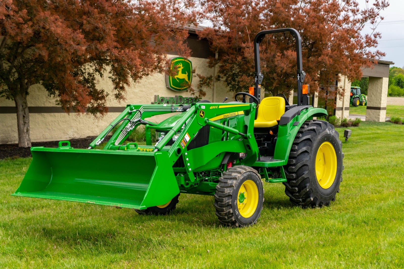 John Deere 4044M with a 400E loader on a lawn