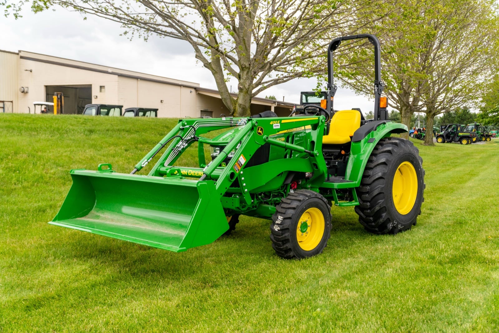John Deere 4052M with a 400E loader on a lawn