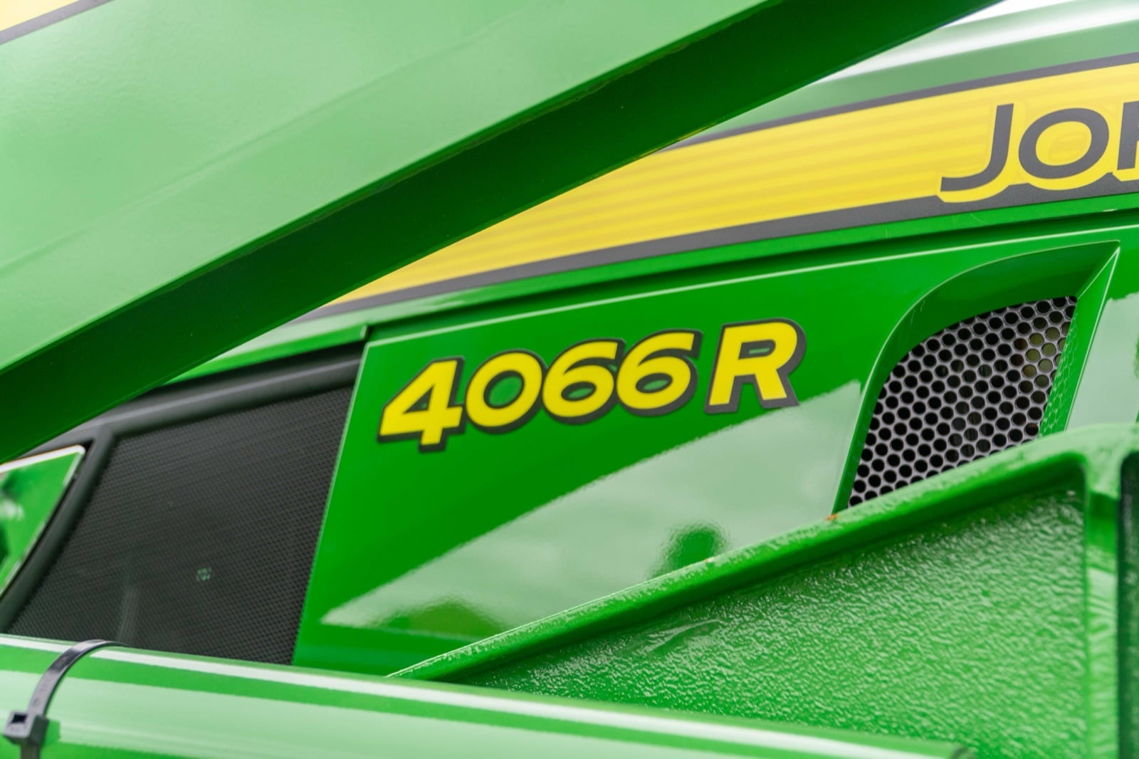 4066R badge on a John Deere compact tractor