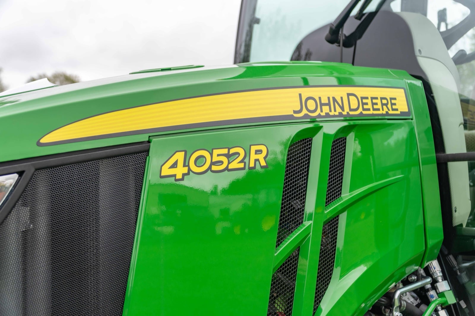 4052R badge on a John Deere compact tractor