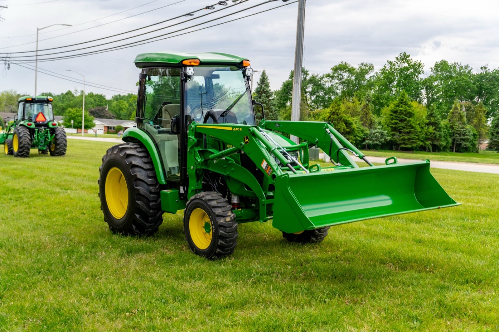 John Deere 4052R with a loader, front three-quarter view