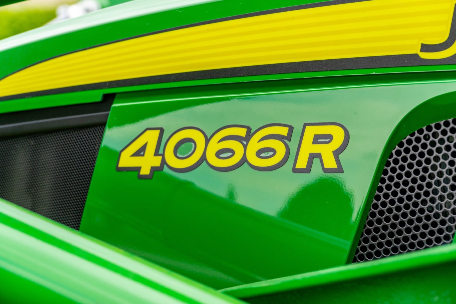 4066R badge on a John Deere compact tractor