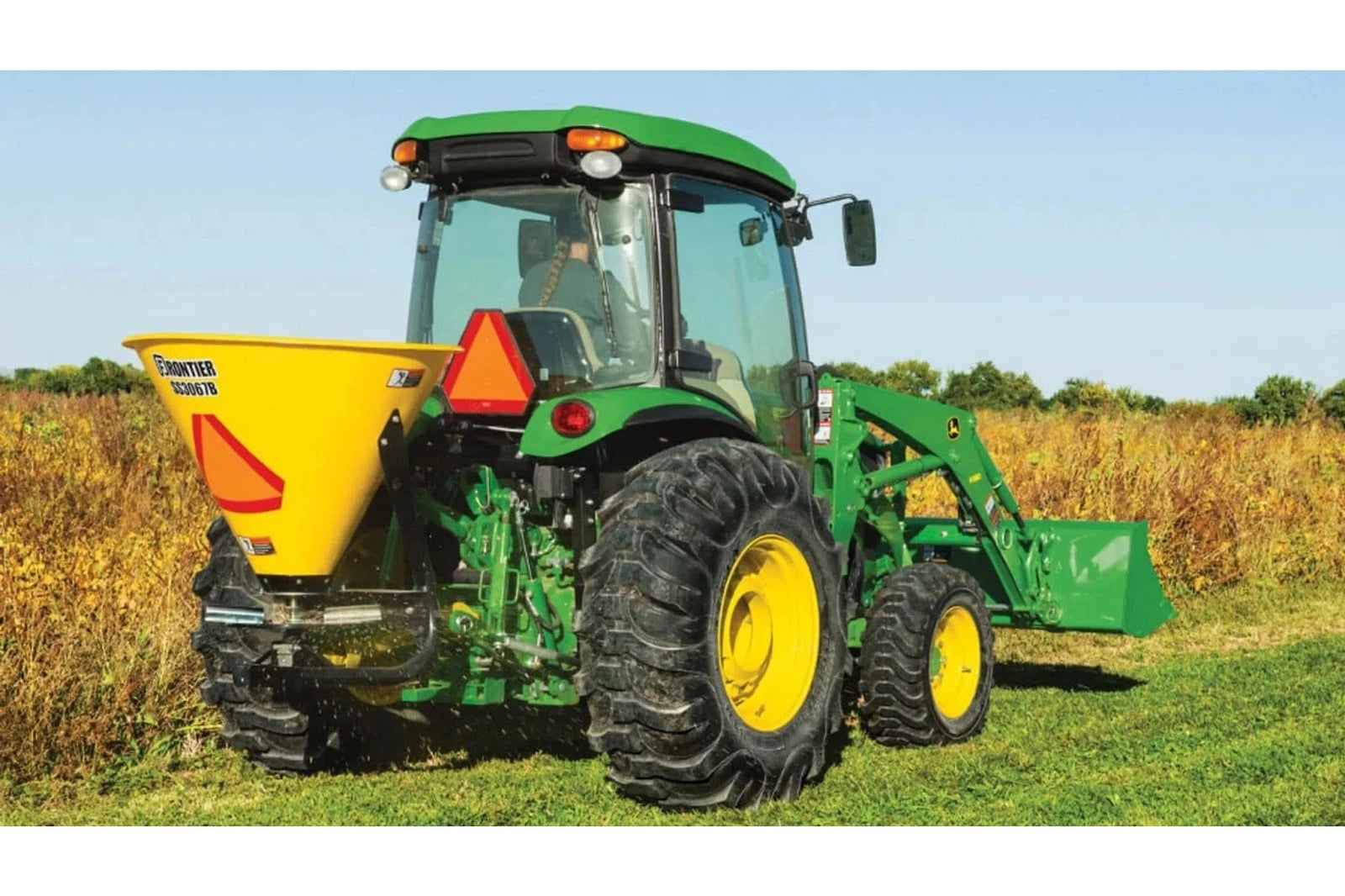 A John Deere 4066R with a rear spreader
