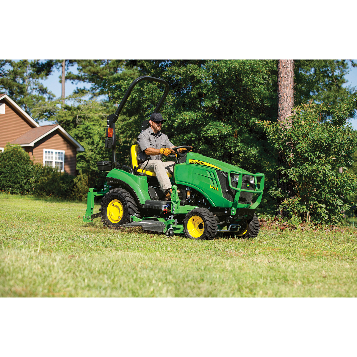 1023E Compact Tractor Mowing a Lawn