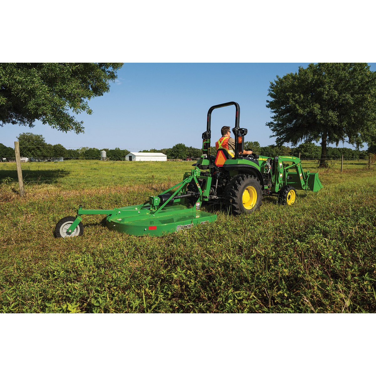 2032R Tractor Mowing a Grassy Field